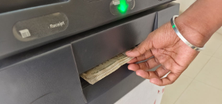 ATM Cash withdrawal - Indian rupees in ATM. Man withdrawing the cash via ATM, business Automatic Teller Machine concept.