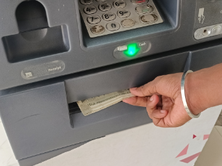 ATM Cash withdrawal - Indian rupees in ATM. Man withdrawing the cash via ATM, business Automatic Teller Machine concept.