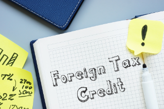 Business concept about Foreign Tax Credit with inscription on the sheet.