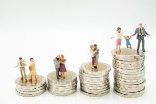 Miniature people: Group of couple and father, Mother, child standing on stack of coins using as background Money, saving planing, financial, insurance, business growth and family concept.