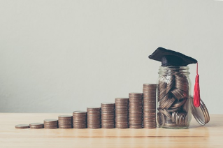 Scholarship money concept. Coins in jar with money stack step growing growth saving money investment