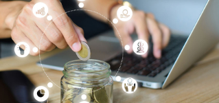 Young man hand putting money coin stack in the jar for the future, growing business, education and retirement. This concept is about saving money and investing money to grow.