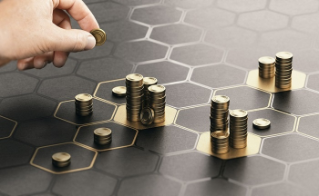 Human hand stacking coins over a black background with hexagonal golden shapes. Concept of investment management and portfolio diversification. Composite image between a hand photography and a 3D back