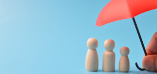 Red toy umbrella and wooden doll figures isolated on a blue background. Insurance coverage concept.