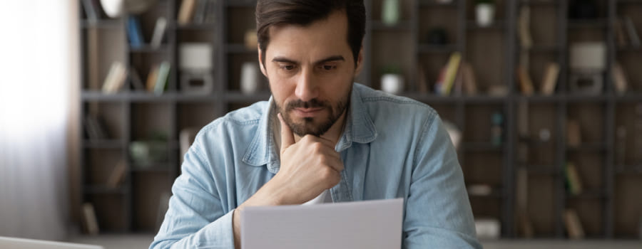 Person reading some documents about Postal Life Insurance (PLI) surrender value