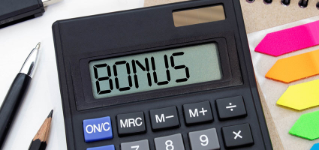 Word BONUS on the display of a calculator on financial documents.