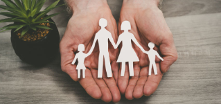Hands protecting a family; symbol of life insurance