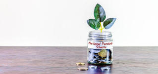 A glass jar full of coins and a plant growing through it. Concept image showing investing in National Pension Scheme can help building wealth.