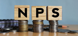 NPS or national pension scheme with wooden bids or blocks on Indian rupees notes.