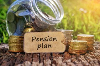 Business Concept - Paper tag written with PENSION PLAN inscription. Coins stack, jar and nature background. 