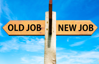 Wooden signpost with two opposite arrows over clear blue sky, Old Job and New Job, Career change conceptual image