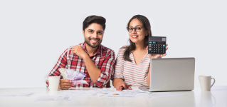 Focused Indian young couple accounting, calculating bills, discussing planning budget together using online banking services and calculator, checking finances