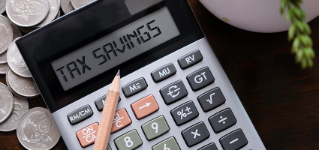 Calculator with text Tax Savings.  Business, finance conceptual. 