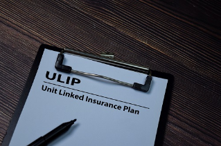 ULIP - Unit Linked Insurance Plan write on paperwork isolated on wooden table.