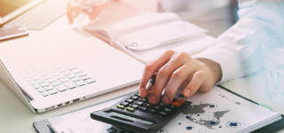 Healthcare costs and fees concept.Hand of smart doctor used a calculator for medical costs in modern hospital 